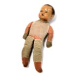 A mid century composition boy doll, with a cloth body, 35.5cm high.