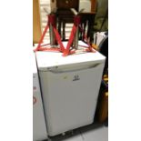 An Indesit fridge and a pair of axle stands. Lots 1501 to 1581 are available to view and collect at