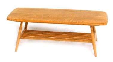 An Ercol light elm coffee table, the rectangular top with a rounded edge, above a slatted under tier