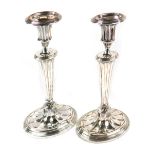 A pair of silver plated candlesticks, each on a shaped fan stem, on a stepped foot, 30cm high.