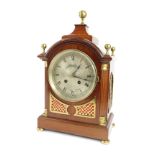 An Edwardian mahogany cased mantel clock, the silvered Roman numeric dial bearing name W. Greenwood