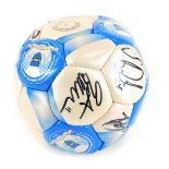 A Peterborough United Football Club football, bearing various signatures, in a branded plastic bag.