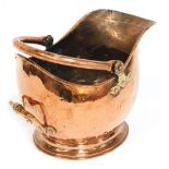 A late 19thC/early 20thC copper helmet shaped coal scuttle, 28cm high.