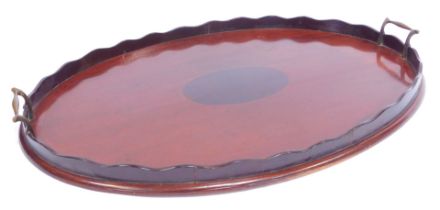 A late 19thC/early 20thC mahogany and inlaid tray, of oval form, with waved galleried border, with t