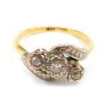 A diamond three stone twist ring, the central section set with three diamonds, in rub over setting,