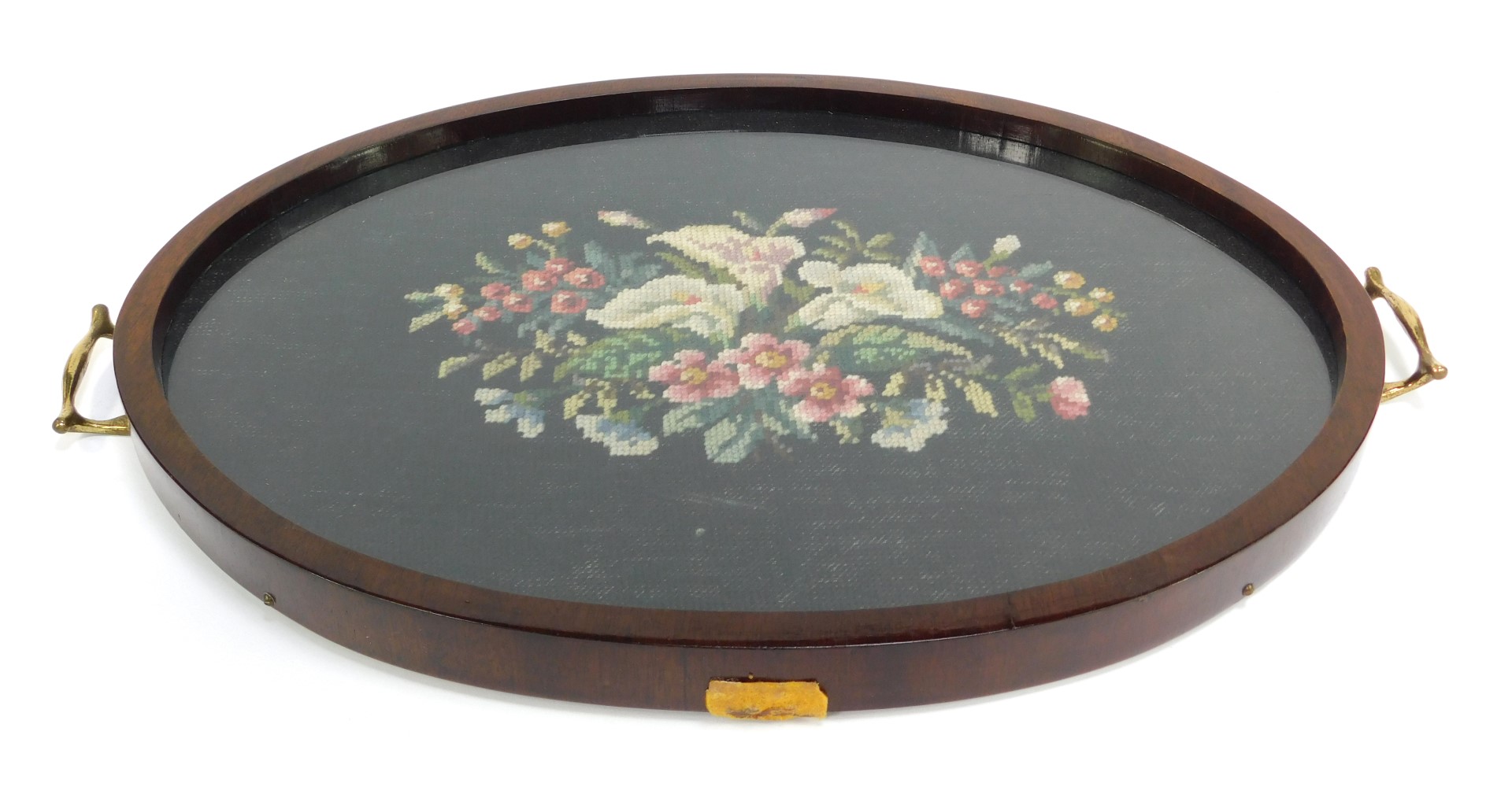 A late 19th/early 20thC mahogany tray, inset centrally with a floral embroidered panel, two brass ha