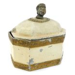 A 18thC lead tobacco jar, handled cast with the head of a man, later painted in cream and gold colou