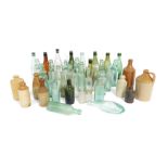 A collection of late 19thC and later glass bottles and stoneware bottles, including Lee and Green Li