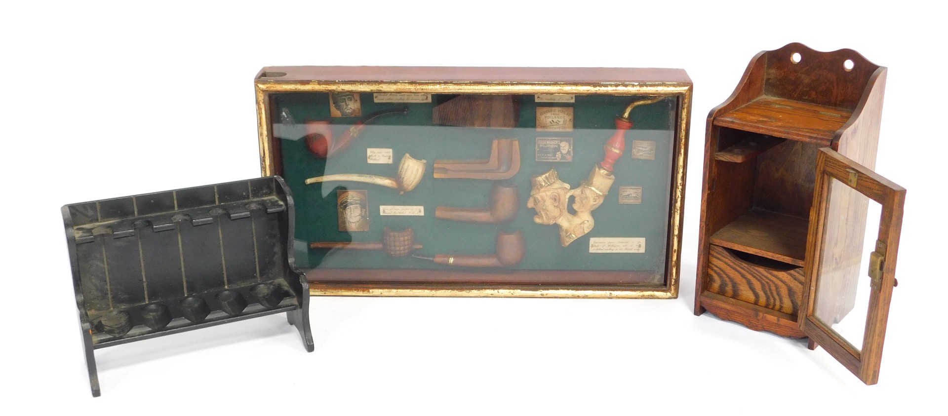 A group of smoking related items, to include a display case containing various reproduction pipes, 5