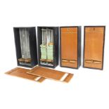 Four pub cigarette dispensers, some containing cigarettes within, 47cm high.