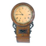 A late 19thC/early 20thC mahogany and inlaid drop dial wall clock, the circular enamel face bearing