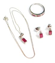 An 9ct white gold ruby and diamond jewellery set, comprising ring, necklace and earrings, the ring s