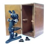 A Beck London wide field x10 microscope, model number 10399, 33cm high, contained in a wooden case.