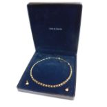 A 9ct gold cultured pearl necklace, three row twist design, with matching earrings, each of single p