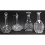 Three cut glass decanters, two with stoppers, together with a claret jug and stopper, 26cm high.