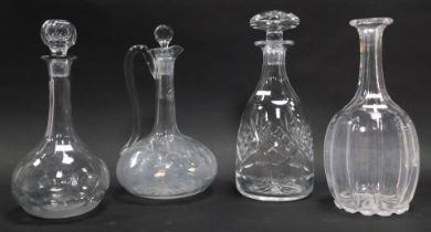 Three cut glass decanters, two with stoppers, together with a claret jug and stopper, 26cm high.