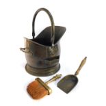 A brass helmet shaped coal scuttle, with scoop, and associated brush. (3)