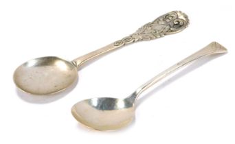 A Georgian silver spoon, with a round flattened bowl, the handle cast with scroll and leaf motifs, h