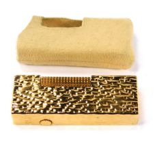 A Dunhill pocket lighter, in gold coloured bark effect case, number 24163, 6.5cm high, with outer su