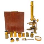 A 19thC brass microscope, unbranded with various accessories and stops, 20cm high, in mahogany case,