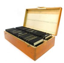 A wooden case containing various slides, depicting Odda, Bondhus Glacier, photograph of a Laplander,