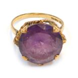 A 9ct gold dress ring, with circular purple paste stone, in claw setting with rope twist raised bask