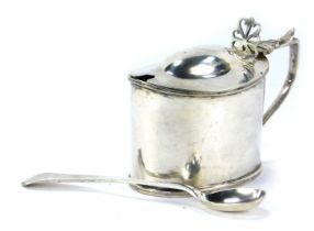An Edward VII silver mustard pot, of oval form, with a fluted lid and pierced thumb piece, maker TH,