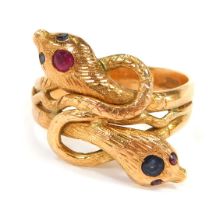 A 9ct gold serpent dress ring, set with rubies and sapphires, with cross over twist design, size S½,