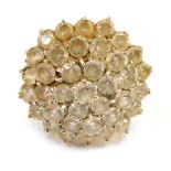 A 9ct gold CZ cluster ring, the chunky design with halo of CZ stones, in a raised basket, size R, 8.