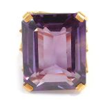 An imitation amethyst dress ring, the rectangular cut stone in a raised basket, with four claw setti