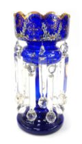 A Victorian Bristol Blue glass lustre, decorated with painted flowers and gilt heightened decoration