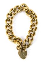 A 9ct gold heavy curb link bracelet, with heart shaped padlock clasp, safety chain as fitted, marked