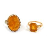 Two dress rings, comprising a rectangular cut citrine, in a raised basket, on yellow metal band stam