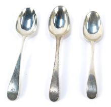 Three Georgian silver dessert spoons, comprising an Old English pattern example with bright cut deco