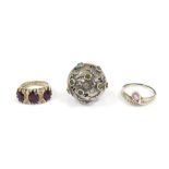 Three dress rings, comprising a white metal bore ring set with green and other rubbed agate, with fa
