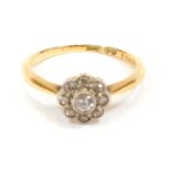 An 18ct gold diamond dress ring, the central floral cluster set with tiny diamonds, in rub over plat