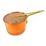 A Divertimenti of London copper saucepan and lid, with brass handle, 25cm diameter.