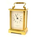 A Taylor and Bligh of London brass carriage clock, with white enamel Roman numeric dial, twin handle