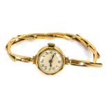 A 9ct gold lady's wristwatch, with small circular watch head with cream numeric dial, on expanding b