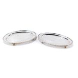 Two silver plated card trays, each of oval form, with engraved scroll decoration, 19cm x 12cm. (2)