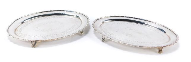 Two silver plated card trays, each of oval form, with engraved scroll decoration, 19cm x 12cm. (2)