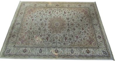 A Kashmir cream ground rug, decorated with a central medallion, flowers and scrolling leaves, within