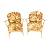 A pair of Ercol beech framed armchairs, model 334, each with a loose floral upholstered seat and bac