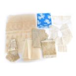 A group of fabric, comprising a Japanese blue Kanebo, section of lace, a cream silk sash with tassel