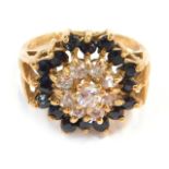 A 9ct gold cluster ring, the central CZ stone surrounded by sapphires, in raised claw setting, ring