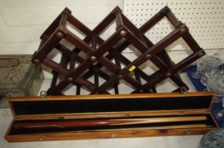 A pine cue case, containing a Formula snooker cue, together with a folding wine bottle rack.
