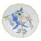 A 19thC Porquier Beau Faience botanical plate, decorated with a blue bird, 23cm diameter.