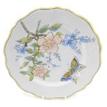A 19thC Porquier Beau Faience botanical plate, decorated with a butterfly, 23cm diameter.