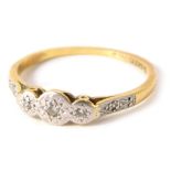 An 18ct gold and plat diamond dress ring, with three illusion set tiny diamonds, and two tiny diamon