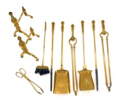 A quantity of brass to include a pair of fire dogs, various fire irons, etc.